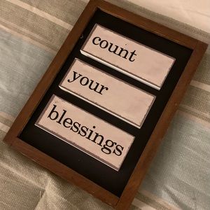 “Count your blessings” brown and black wood wall decor.